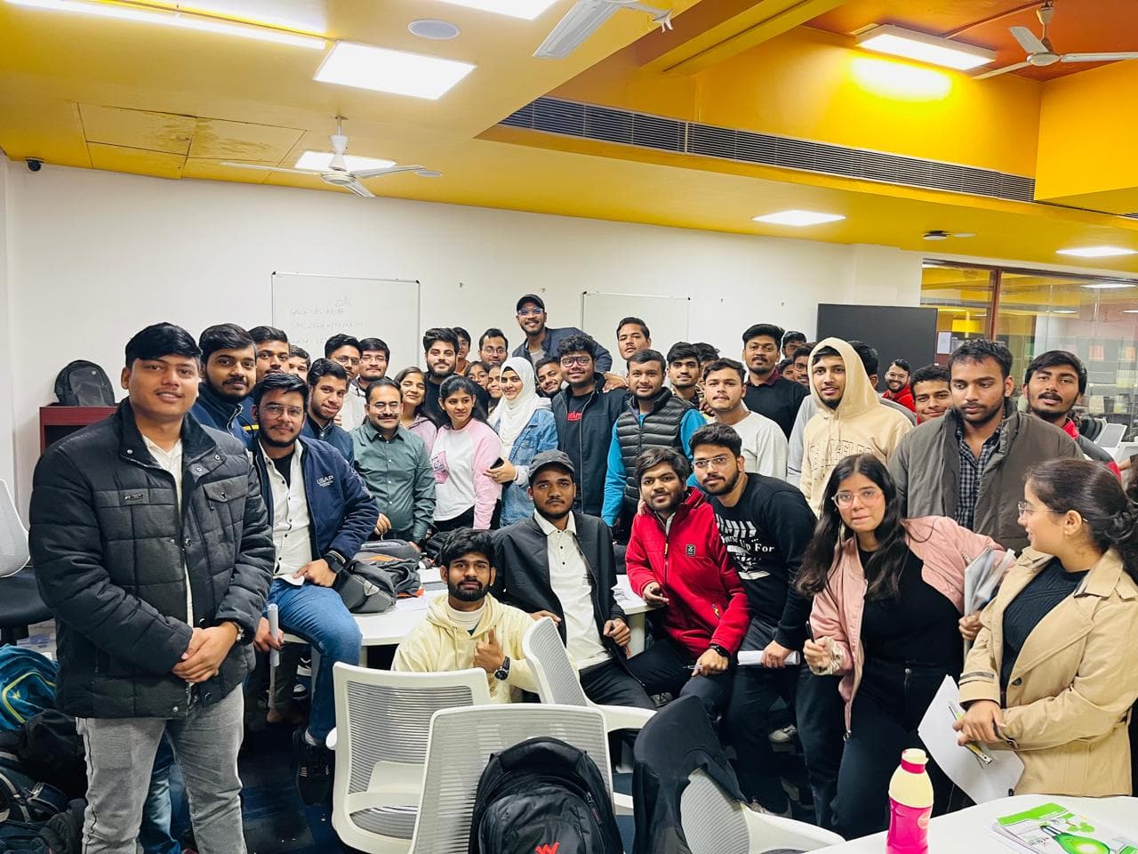 Students and their mentor gathered in a classroom after a session